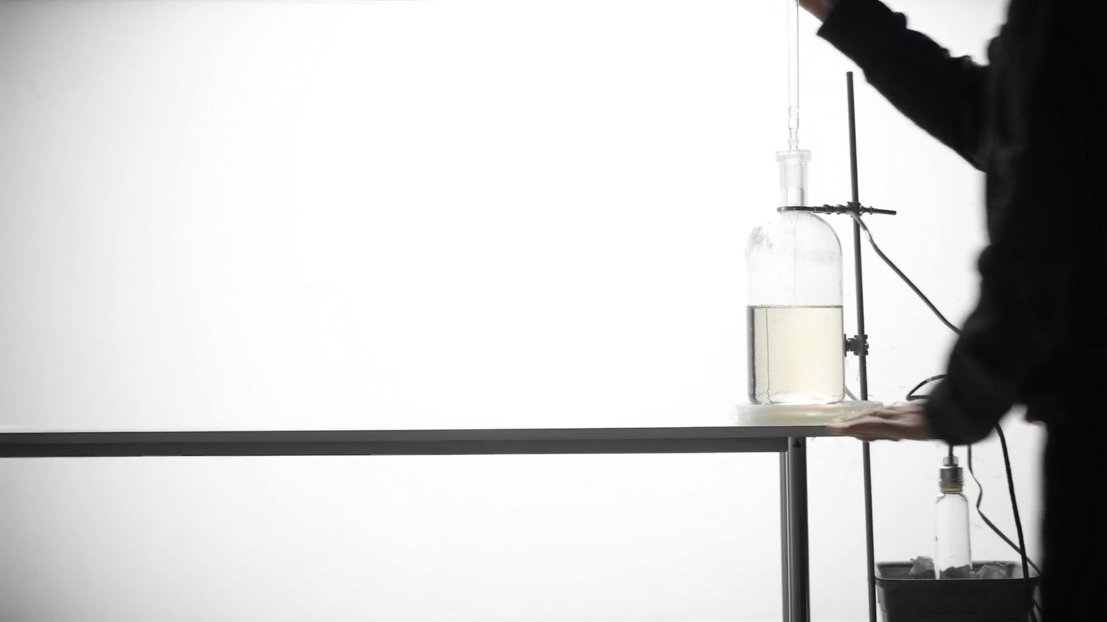 a dark 16:10 picture, one instrument lit in a dark room, the left half calm