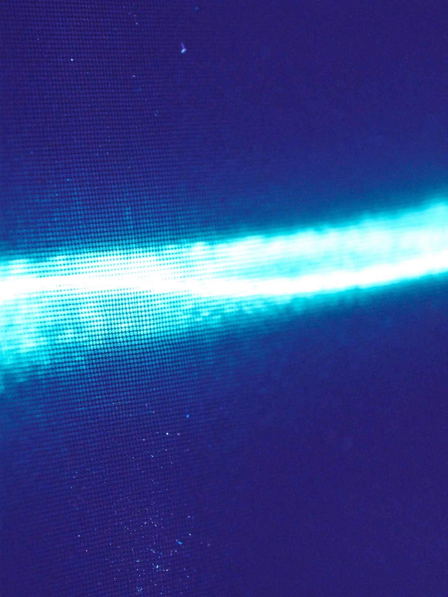 A fine blue mesh with a band of light crossing it